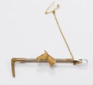 A 9ct gold brooch in the form of a horse and whip with textured detail, 6.5g, width 6cm x length 1.