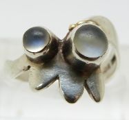 A silver ring set with two moonstone cabochons (size M)