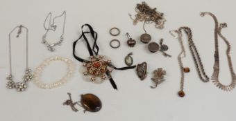 A collection of silver jewellery including Victorian buttons, necklaces, Wedgwood pendant, tiger's
