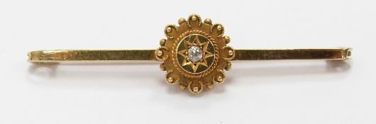 A 15ct gold brooch set with a diamond in a star setting
