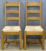 A pair of rush seated ladder back chairs