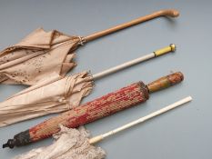 Four parasols including guilloche enamel handled example surmounted by a rose cut diamond of