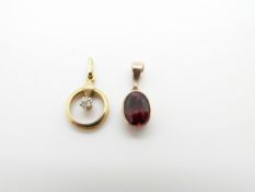 A 9ct gold pendant set with an oval garnet and a 9ct gold pendant set with a diamond, 2g