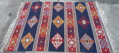 Hand woven rug with geometric pattern, 245 x 175cm