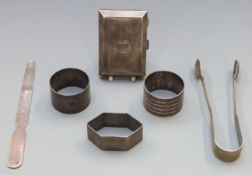 Three hallmarked silver napkin rings, hallmarked silver letter opener dated 1901, sugar tongs and