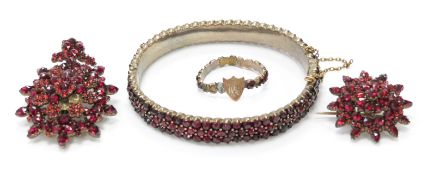 A suite of Victorian Bohemian garnet jewellery comprising brooch, pendant, bangle and ring