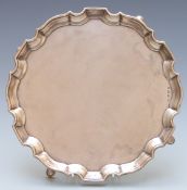 George VI hallmarked silver salver with shaped edge, raised on four feet, Birmingham 1937 maker