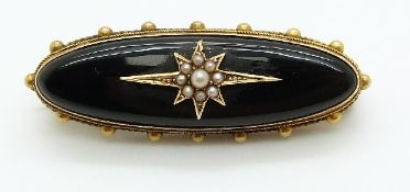 Victorian brooch set with onyx and seed pearls to the centre in a star setting