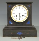 A black slate mantel clock with inlaid lapis lazuli or similar and two train movement striking on