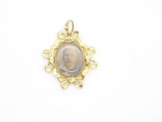 Edwardian 15ct gold pendant set with seed pearls in stylised bow design with photographs to both