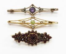 Victorian brooch set with Bohemian cut garnets, an Edwardian brooch set with peridot and seed pearls