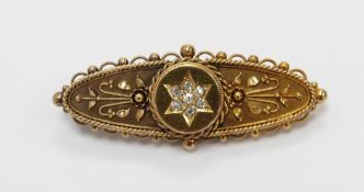 Edwardian 15ct gold brooch set with diamonds in a star and wire work detail, with glass