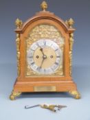 Goldsmiths Company of London Edwardian oak cased mantel clock with brass figural and floral