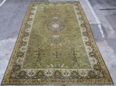 Large Axminster rug with green ground, 455 x 275cm
