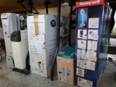 Two small boxed electric heaters, two further heaters and two fans