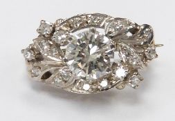 An 18ct white gold brooch set with a round brilliant cut diamond measuring approximately 1ct