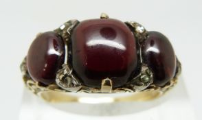 An early Victorian ring set with garnet cabochons and rose cut diamonds (size N)