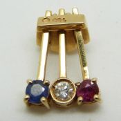 An 18ct gold pendant set with a diamond, ruby and sapphire
