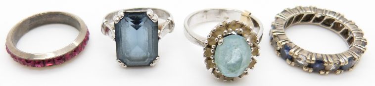 A silver ring set with blue and clear sapphires, two silver rings and another ring