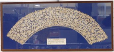 An unusually large 17thC Venetian lace needlepoint collar mounted in a glazed frame, 55 x 124cm