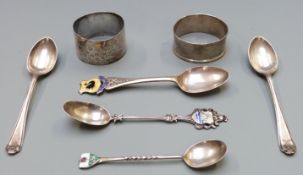 Two hallmarked silver napkin rings and five various hallmarked silver spoons, some with enamel