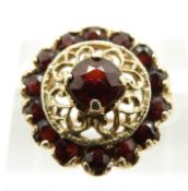 A 9ct gold ring set with garnets in a pierced setting, in original box (size M)