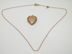 A 9ct gold chain (1.5g) and 9ct gold back and front heart locket