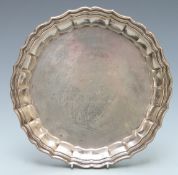 Spanish white metal salver with shaped edge raised on four feet, with Spanish silver marks, diameter