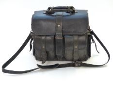 A black leather doctor's bag with shoulder strap