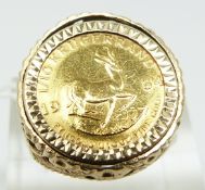 A 9ct gold ring set with a 1984 1/10 Krugerrand, 6.8g (size N)