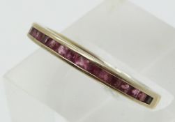 A 9ct gold eternity ring set with garnets (size O)