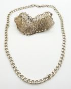 A silver curb link necklace and a silver filigree bracelet