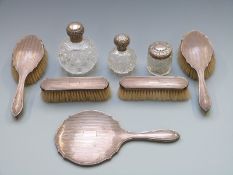 Three hallmarked silver mounted cut glass dressing table bottles, two being of hobnail cut design