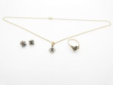 A suite of 9ct gold jewellery set with sapphires and diamonds comprising ring, earrings, and