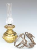 Brass oil lamp with a cast iron wall bracket