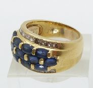 An 18ct gold ring set with 13 oval sapphires and 22 princess cut diamonds (size Q)