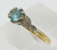 An 18ct gold ring set with a zircon and diamonds in platinum setting (size M)
