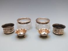 Three pairs of hallmarked silver and silver mounted salts, one pair on three ball feet Birmingham