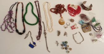 A collection of beaded necklaces including agate, garnet, a malachite pendant, silver beads, pearls,