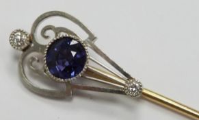 Art Nouveau stick pin set with a round cut natural, untreated colour change sapphire of