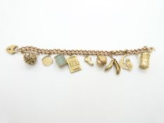 A 9ct rose gold charm bracelet with five 9ct gold charms, 35.4g