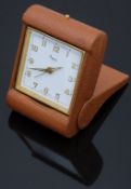 Asprey gold plated travelling alarm clock with gold and luminous hands, Arabic numerals, white