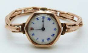 A 9ct rose gold ladies watch on a 9ct gold strap