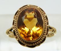 A 9ct gold ring set with an oval cut citrine (size J)