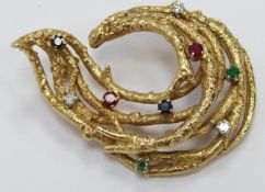 An 18ct gold textured brooch set with diamonds, emeralds, rubies and sapphires, by HGM, 13.6g, width