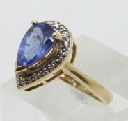 A 9ct gold ring set with a pear cut tanzanite and diamonds (size N)