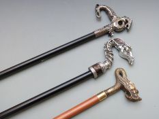 Three walking canes with novelty dragon or similar mythical creature handles one in the Oriental