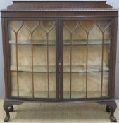 Early 20thC mahogany bow fronted glazed display cabinet raised on ball and claw feet, W122 x D36 x