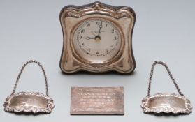 Modern hallmarked silver mounted clock, height 9.5cm, two hallmarked silver bottle tickets, one