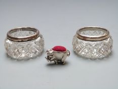 A pair of hallmarked silver mounted cut glass salts and a small novelty pig pin cushion marked 925